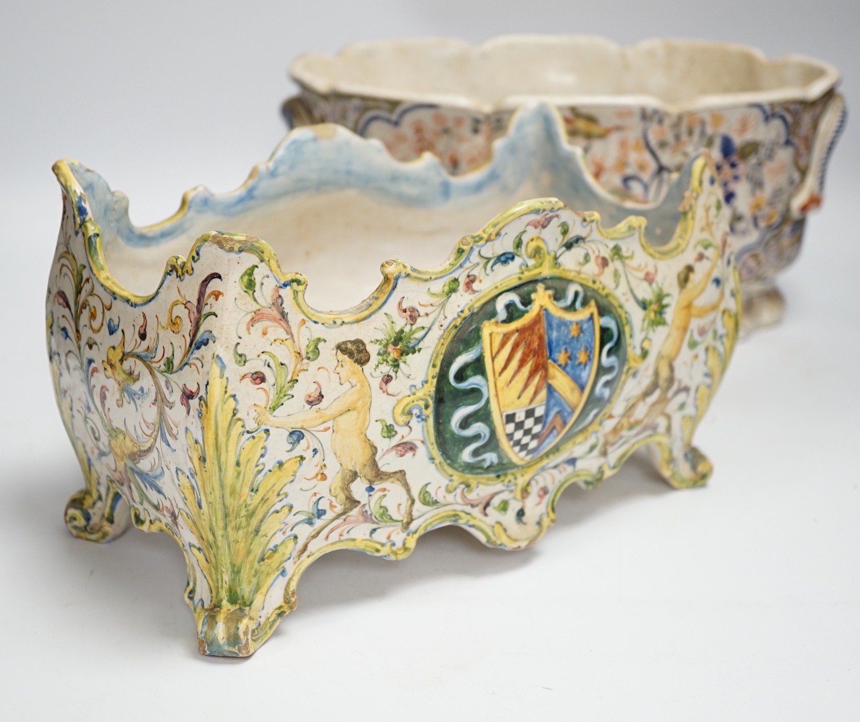 A Two French faience pottery planters, one with armorial crest and another, longer 34cm (2)